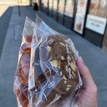 Mr Bakery - a hand holding a sandwich wrapped in plastic - Bakeries Near Me - Aurora, Colorado