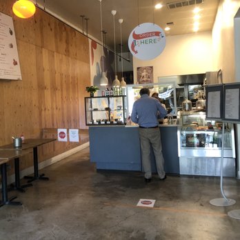 Bloom - Yummy desserts in the case and social distance markers - Coffee & Tea Near Me - Los Angeles, California
