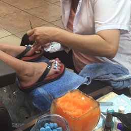 Adding little gems to her toes