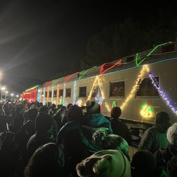 Lines of people packed together to board the train Lines of people packed together to board the train