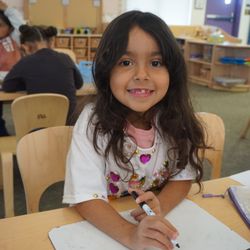 Creekside Elementary School - Student in Transitional Kinder sitting at a desk