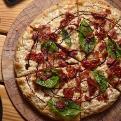 Illuminati Pizza - Artichoke pizza with dry tomatoes, basil and Serrano ham