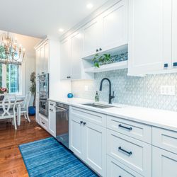 KRB Kitchen and Bath Design Center - A bright white galley kitchen.