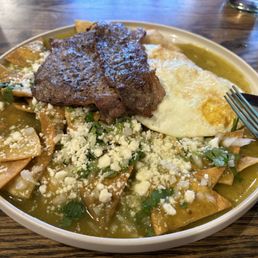Chilaquiles with skirt steak. Chilaquiles with skirt steak.