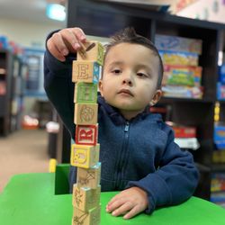Lauren's Institute For Education - Child building a block tower.