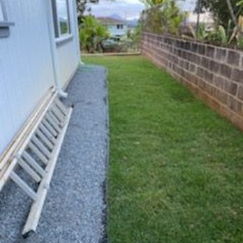 JBL Landscaping Services - side of house with rock layer outline around house - Landscaping Near Me