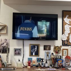 Scorpio Rising Tattoo - TV with a show I like, Jeff's cool art, supplies, and some oddities as decor.