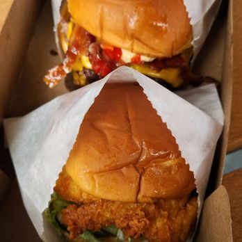 Shake Shack Valley Fair - Close: Chicken sandwich, far: beef sandwich with bacon - Fast Food Near Me - Santa Clara, California Shake Shack Valley Fair - Close: Chicken sandwich, far: beef sandwich with bacon - Fast Food Near Me - Santa Clara, California