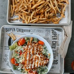 A picture of the Nashville Hot Salad and A large order of fries