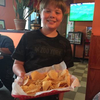 La Hacienda - a boy holding a basket of chips - Mexican Near Me - Wamego, Kansas La Hacienda - a boy holding a basket of chips - Mexican Near Me - Wamego, Kansas