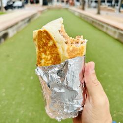 Enjoying a burrito at the park