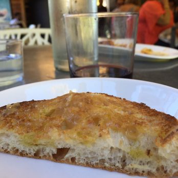 Bravas Bar de Tapas - Hot bread from the oven slathered in butter and oven roasted garlic.... - Spanish Near Me - Healdsburg, California