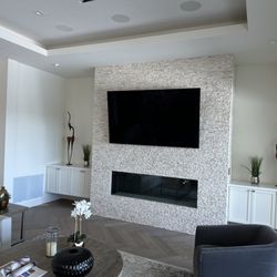 High Performance AV - Sony 83" oled display mounted above a fireplace to match in Danville