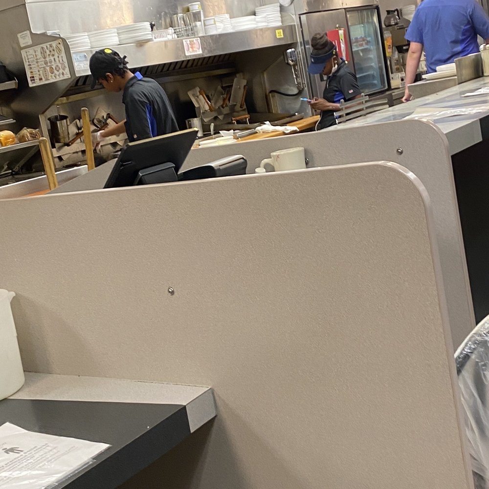 Worker on phone while cooking with no gloves Worker on phone while cooking with no gloves