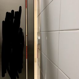 The gap between the stall and the wall