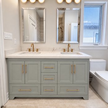 Dahlia Cabinetry - Bathroom vanity in Sherwin-Williams Sea Salt (SW 6204) with gold hardware and a light countertop - Cabinetry Near Me Dahlia Cabinetry - Bathroom vanity in Sherwin-Williams Sea Salt (SW 6204) with gold hardware and a light countertop - Cabinetry Near Me