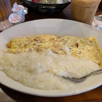 Mena's Palace - Pork Tasso Omelette with classic grits - Breakfast & Brunch Near Me - New Orleans, Louisiana Mena's Palace - Pork Tasso Omelette with classic grits - Breakfast & Brunch Near Me - New Orleans, Louisiana