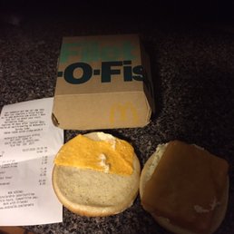 a sandwich and a receipt on a counter a sandwich and a receipt on a counter