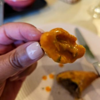 Canje - A saucy bite of the oxtail patties - Caribbean Near Me - Austin, Texas
