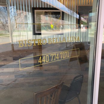 Bistro Bella Luna - a chair in front of a window - Bakeries Near Me - Oberlin, Ohio