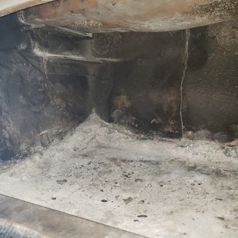 Chimney Technologies - Fireplace with disintegrated firebrick on the edges - Chimney Sweeps Near Me Chimney Technologies - Fireplace with disintegrated firebrick on the edges - Chimney Sweeps Near Me