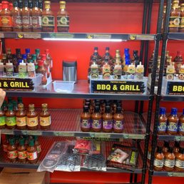a shelf of barbecue sauces and sauces a shelf of barbecue sauces and sauces