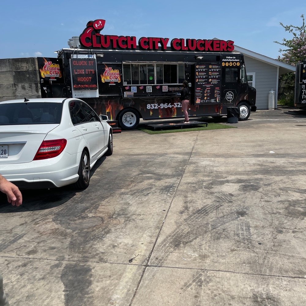 a car parked in front of a food truck