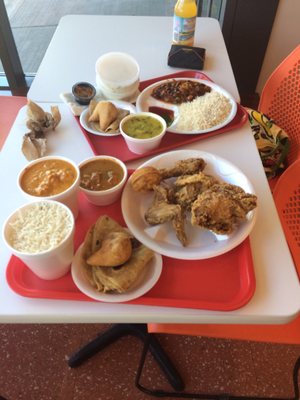 Photo of Rajun Cajun - Chicago, IL, US. Butter chicken, goat curry, samosa, paratha, basmati rice, Rajun, lentil
