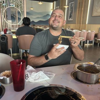 Ombu Hotpot & Korean BBQ - Guy enjoying his food and surroundings - Barbeque Near Me - Marrero, Louisiana