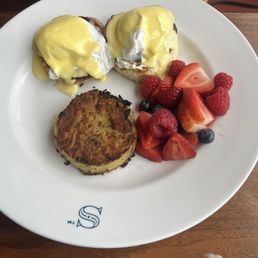 Eggs Benedict with hash browns.