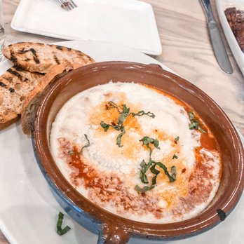 Answer - baked eggs. tomato sauce, basil, pecorino, chile oil, grilled bread. This was Delicious. - Tapas/Small Plates Near Me - Nashville, Tennessee