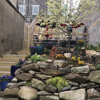 Maggie’s - a stone wall with a tree in the middle - Sandwiches Near Me - Fredericksburg, Virginia