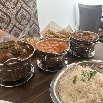Moonsun India Grill - (Left to right) Special Goat Curry, Chicken Tikka Masala, Lamb Curry +Lamb Biryani and Naan - Indian Near Me - Lynnwood, Washington