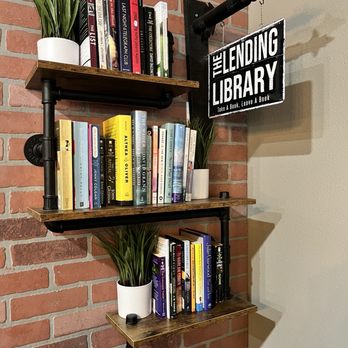 Warehouse Coffee - a shelf with books and plants - Coffee & Tea Near Me - Spring Hill, Florida