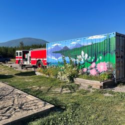 Storage container for supplies decorated with painted flowers.