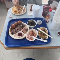 Pulled pork, greens, hush puppies, and Lexington bbq sauce on the side