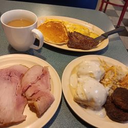 The Cottage Restaurant - Medium rare steak Pancakes scrambled eggs country Han biscuits with country gravy hashbrowns and sausages with coffee