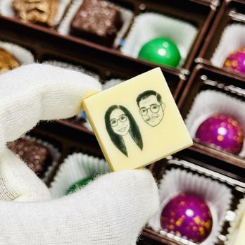 Albert's Petite Sweets - A photo from Chef during the custom making process. He put our logo on white chocolate. - Desserts Near Me - Long Beach, California Albert's Petite Sweets - A photo from Chef during the custom making process. He put our logo on white chocolate. - Desserts Near Me - Long Beach, California