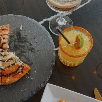 Jane - Southlake - a slice of pizza on a plate next to a glass of orange juice - Wine Bars Near Me - Southlake, Texas