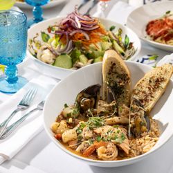 Primavera Ristorante - A spread of dishes for dinner service including Cioppino
