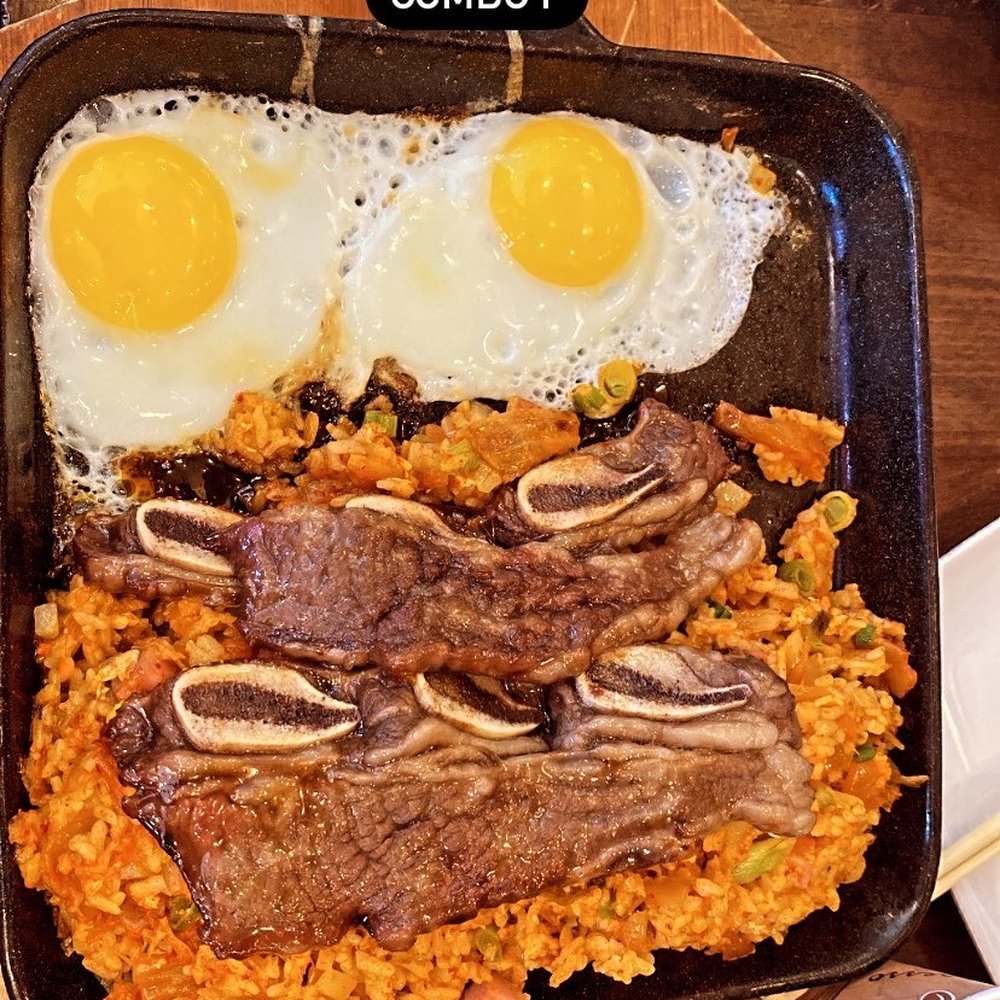 a plate of food with meat, rice, and eggs a plate of food with meat, rice, and eggs
