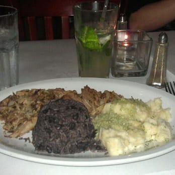 Mojitos - Norcross - Lechón asado con yuca con mojo y congris (roasted pork w/ yuca/garlic sauce and white rice/black beans - Cuban Near Me - Norcross, Georgia