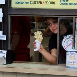 Serving a SMALL cone at the Golden Gurnsey Ice Cream take-out window in the parking lot.