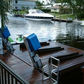 DSI Marine Construction - a dock with chairs and a boat - General Contractors Near Me - Fort Myers, Florida DSI Marine Construction - a dock with chairs and a boat - General Contractors Near Me - Fort Myers, Florida