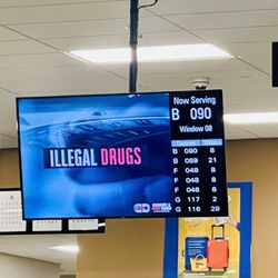 Department of Motor Vehicles - Several TV monitors to watch for your number .
