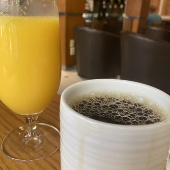 Bistro Ten Zero One - a glass of orange juice and a cup of coffee - American Near Me - West Palm Beach, Florida