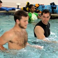 Complete PT Pool & Land Physical Therapy - Kevin Wagner, MSPT works with a patient in the pool.