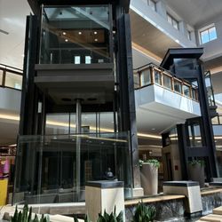 The Shops at Willow Bend - Brown Glass Schindler RT 300A center court elevators, The Shops at Willow Bend