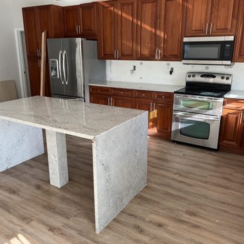 P Construction - a kitchen with wood cabinets and stainless steel appliances - Countertop Installation Near Me P Construction - a kitchen with wood cabinets and stainless steel appliances - Countertop Installation Near Me