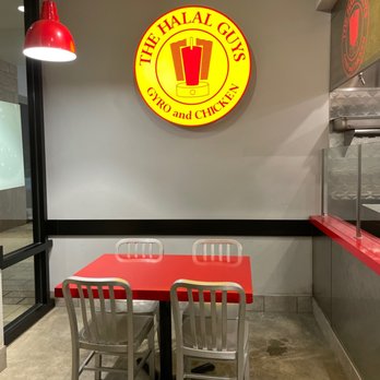 The Halal Guys - a table and chairs in a restaurant - Halal Near Me - Davie, Florida